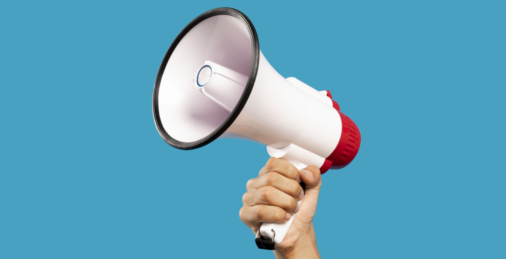 Photograph of a megaphone with a blue background